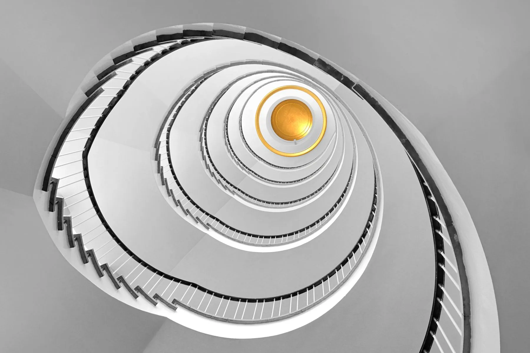 A white spiral staircase seen from above