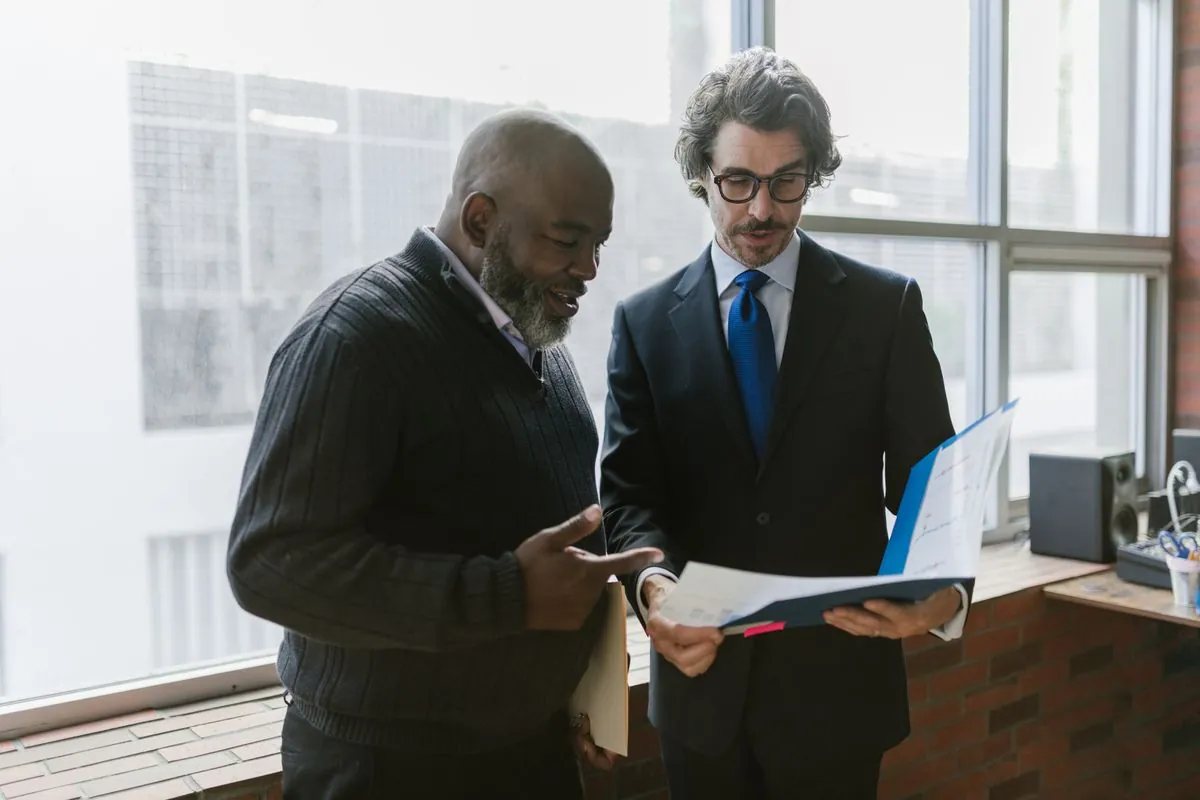 Two people going through a document together in a bright office